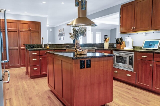5007 S 42nd St, Climax, MI 49034 - kitchen with a kitchen island, stainless steel microwave, a peninsula, light wood-type flooring, and crown molding