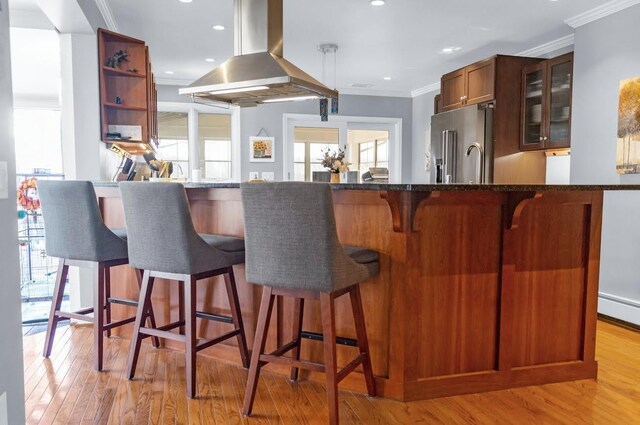5007 S 42nd St, Climax, MI 49034 - kitchen featuring island exhaust hood, high quality fridge, ornamental molding, healthy amount of natural light, and light wood finished floors