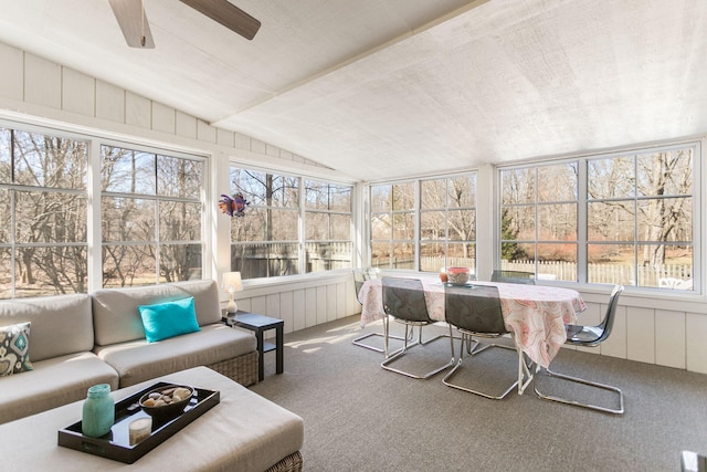 sunroom featuring a ceiling fan and vaulted ceiling