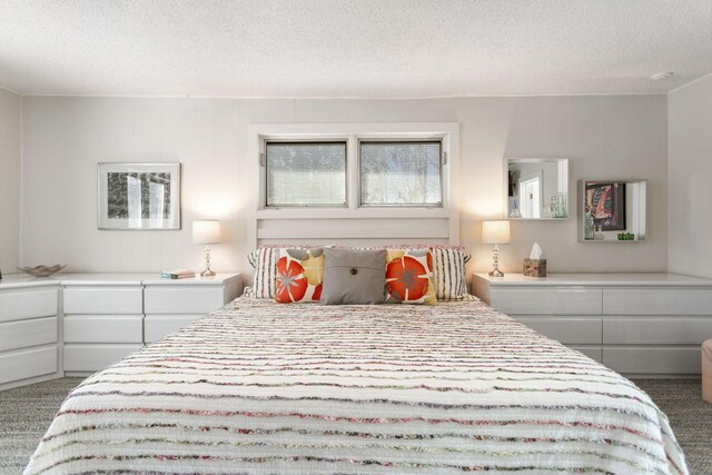 bedroom featuring carpet flooring and a textured ceiling