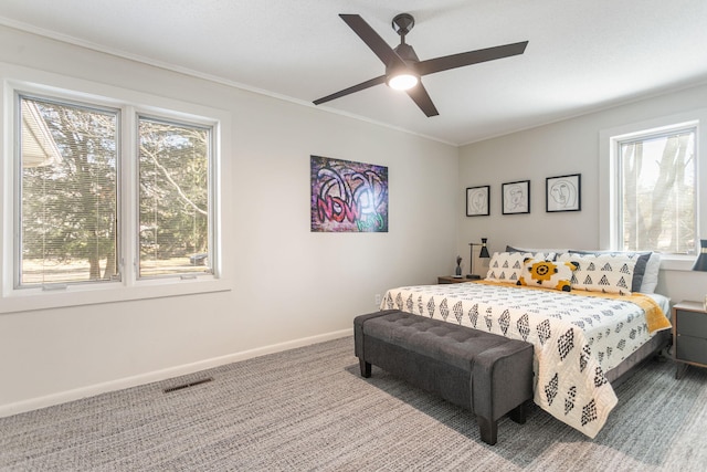 bedroom with visible vents, baseboards, carpet flooring, and crown molding