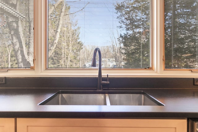 kitchen with dark countertops and a sink