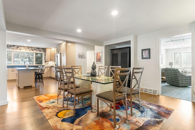 dining area with recessed lighting, wood finished floors, visible vents, and a wealth of natural light