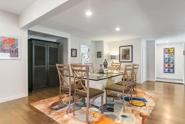 dining space featuring recessed lighting, baseboards, and wood finished floors