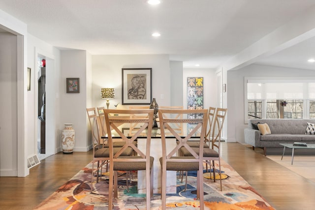 dining space featuring dark wood finished floors and recessed lighting