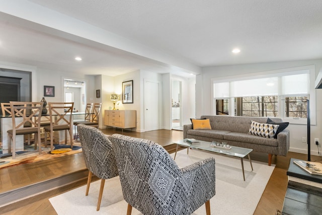 living area with recessed lighting and wood finished floors