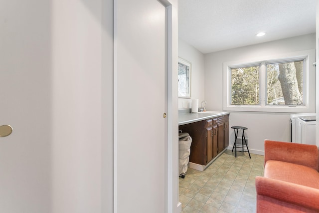 bathroom with recessed lighting, baseboards, independent washer and dryer, and vanity