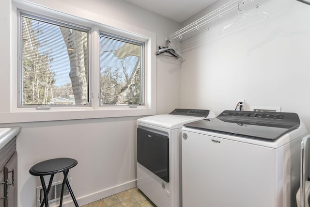 laundry area with light tile patterned floors, visible vents, baseboards, laundry area, and washer and clothes dryer