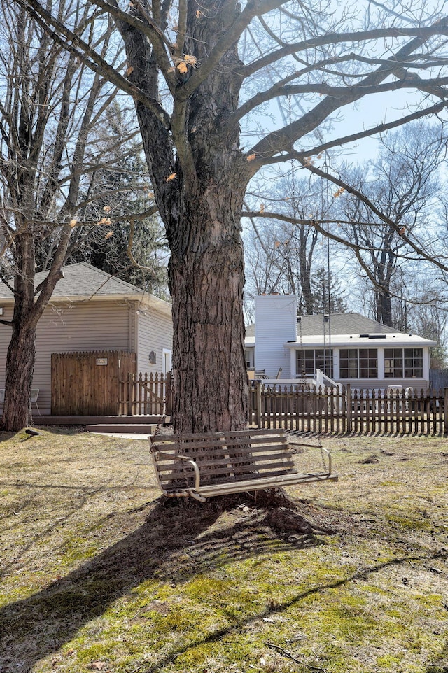 exterior space featuring a fenced front yard and a sunroom