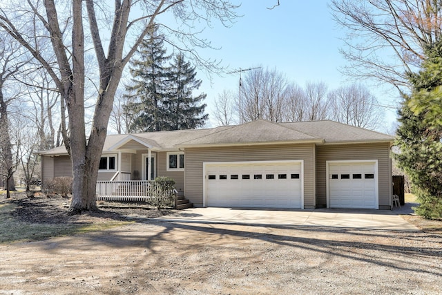 ranch-style house with covered porch, concrete driveway, and an attached garage