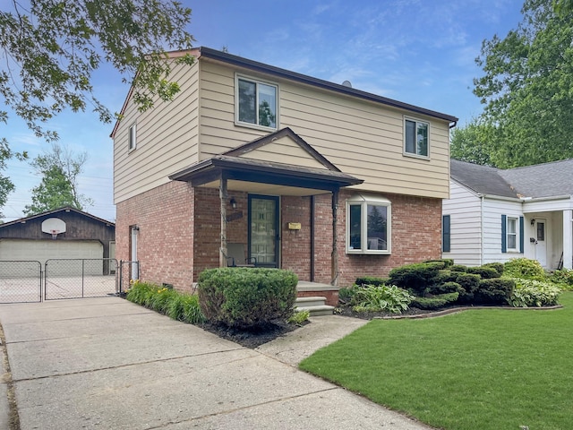 view of front of home with a detached garage, an outbuilding, a gate, a front lawn, and brick siding