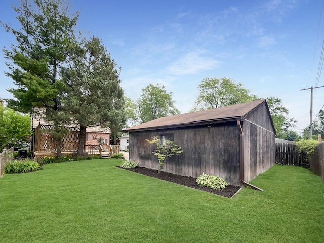 view of yard featuring a fenced backyard, an outdoor structure, and a wooden deck