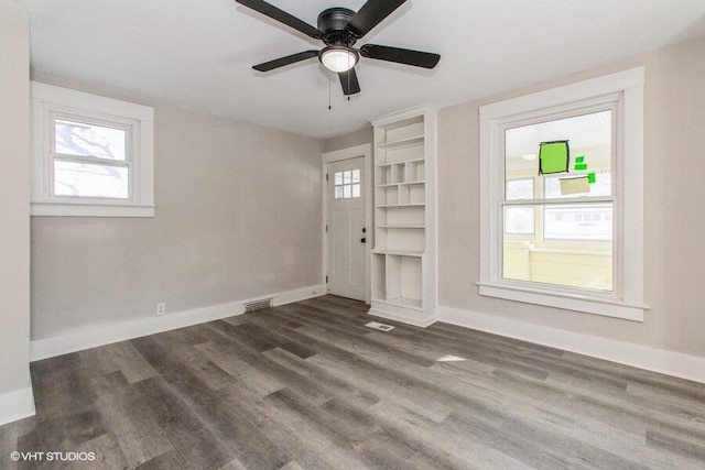 entrance foyer with visible vents, baseboards, and dark wood-type flooring