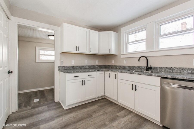 kitchen featuring dishwasher, wood finished floors, a sink, and white cabinets