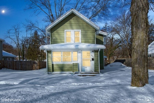 view of front of home featuring fence