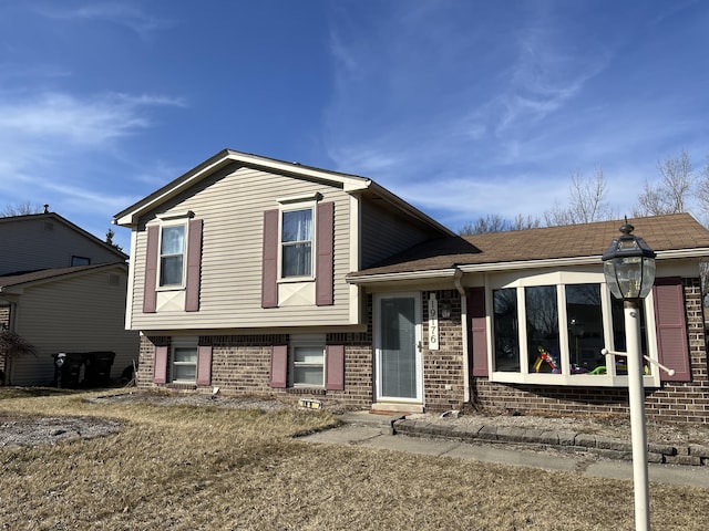 tri-level home with brick siding