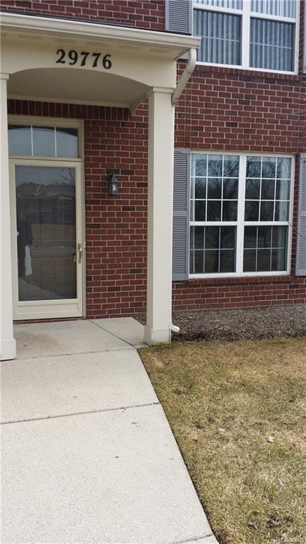 view of exterior entry with brick siding