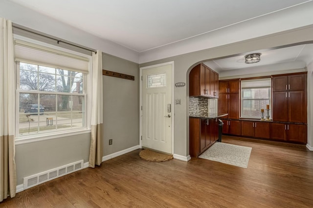 interior space featuring a wealth of natural light, wood finished floors, and visible vents