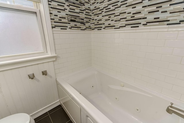 full bathroom featuring toilet and tile patterned flooring