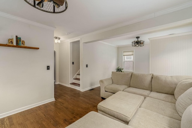 living area with stairs, ornamental molding, baseboards, and wood finished floors