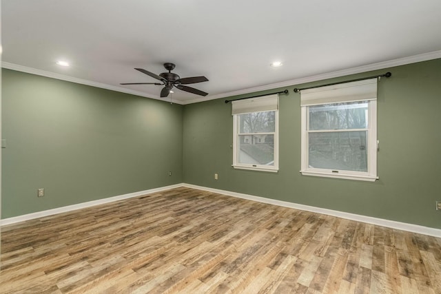 empty room with ceiling fan, recessed lighting, wood finished floors, baseboards, and crown molding