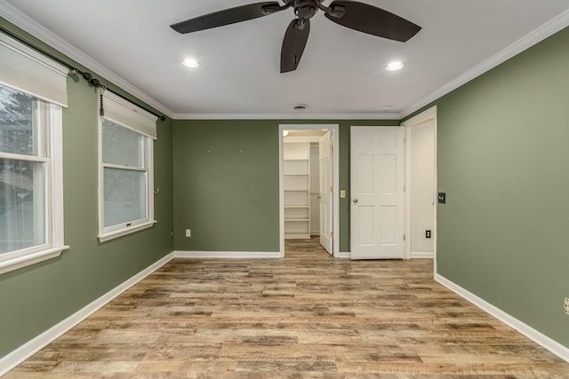 unfurnished bedroom with baseboards, ornamental molding, and wood finished floors