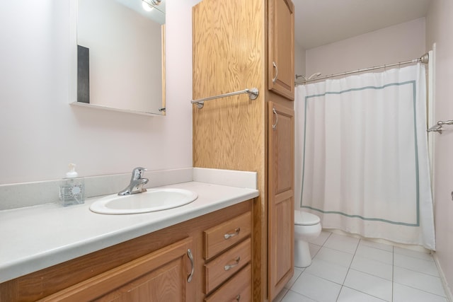 full bath with toilet, vanity, and tile patterned floors