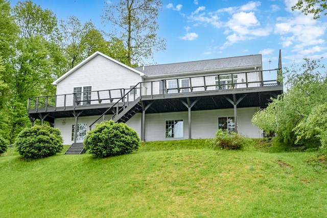 back of house featuring a lawn and a deck