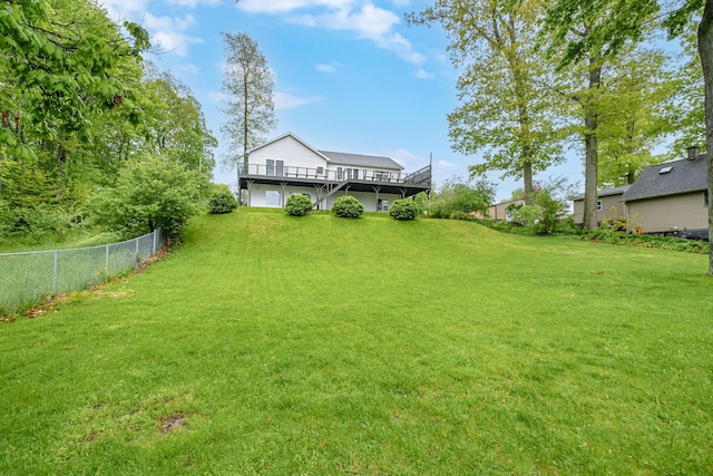 view of yard featuring fence and a deck