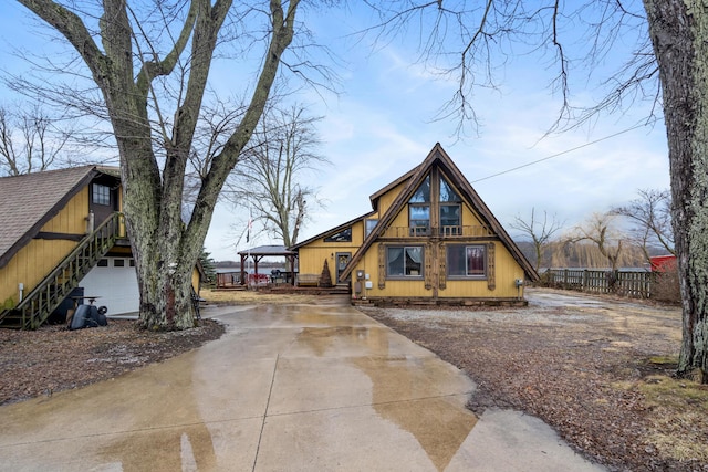 exterior space with driveway and a detached garage