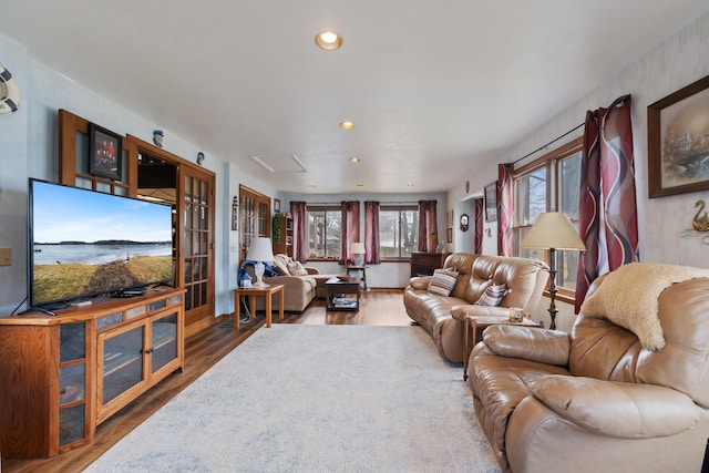 living room with wood finished floors and recessed lighting