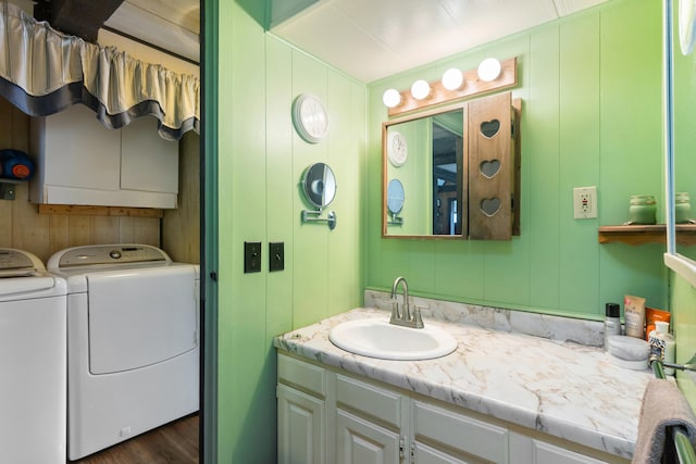 bathroom featuring washing machine and dryer and vanity