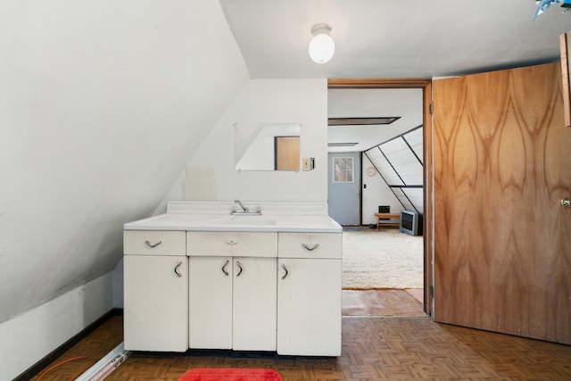 bathroom featuring lofted ceiling and vanity