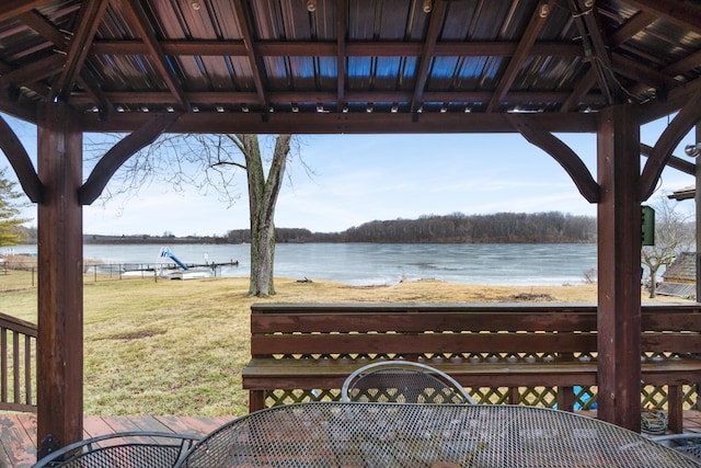 deck featuring a yard, a water view, and a gazebo