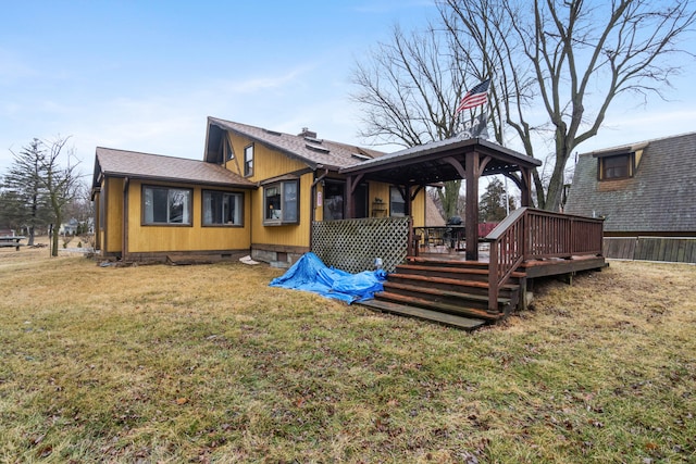 rear view of property with crawl space, roof with shingles, a lawn, and a chimney