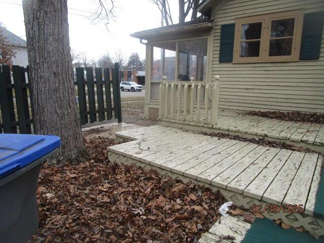 exterior space with a sunroom and fence