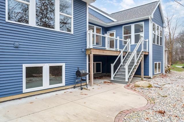 4030 Hollow Wood Dr, Portage, MI 49024 - back of property with a patio, stairway, and roof with shingles