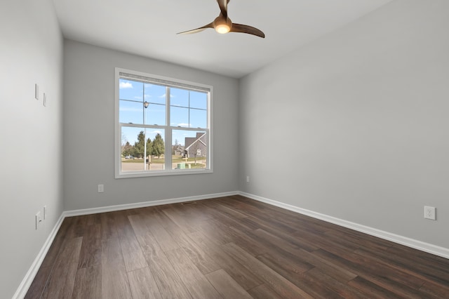 4030 Hollow Wood Dr, Portage, MI 49024 - spare room with dark wood-style flooring, baseboards, and ceiling fan