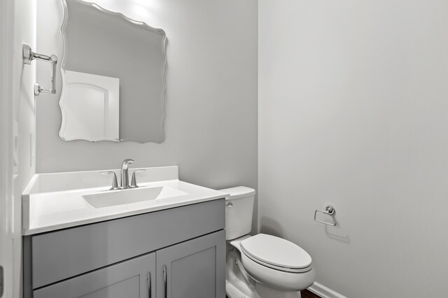 4030 Hollow Wood Dr, Portage, MI 49024 - bathroom with toilet, vanity, and baseboards