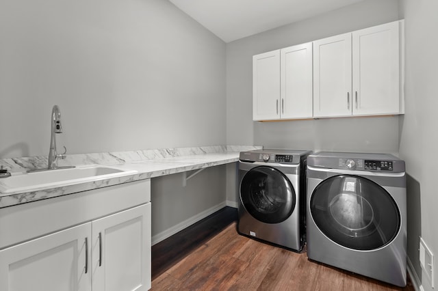 4030 Hollow Wood Dr, Portage, MI 49024 - clothes washing area featuring a sink, cabinet space, dark wood-style floors, and washer and dryer