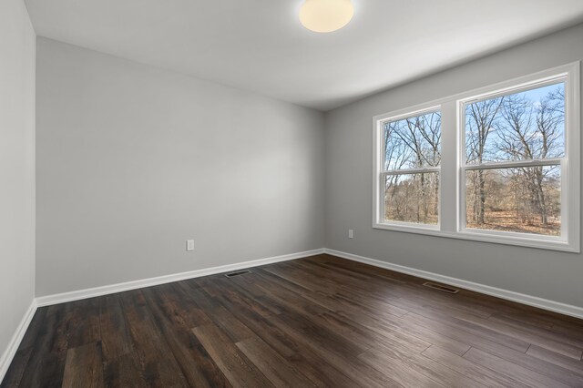 4030 Hollow Wood Dr, Portage, MI 49024 - unfurnished room featuring dark wood-style flooring, baseboards, and visible vents