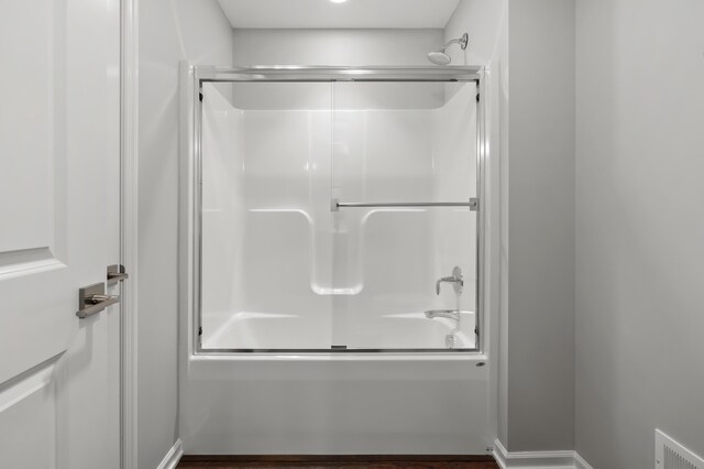 4030 Hollow Wood Dr, Portage, MI 49024 - full bathroom featuring baseboards, visible vents, and shower / bath combination with glass door