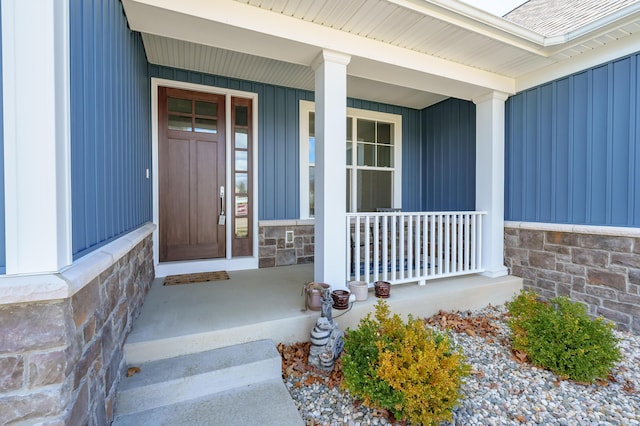 4030 Hollow Wood Dr, Portage, MI 49024 - doorway to property featuring stone siding and covered porch