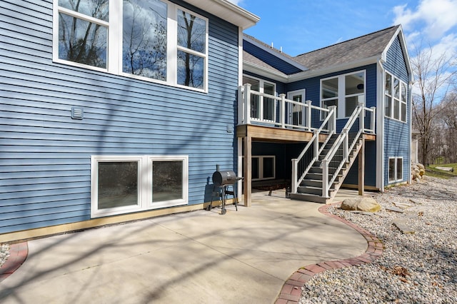 4030 Hollow Wood Dr, Portage, MI 49024 - rear view of house featuring stairway, roof with shingles, and a patio
