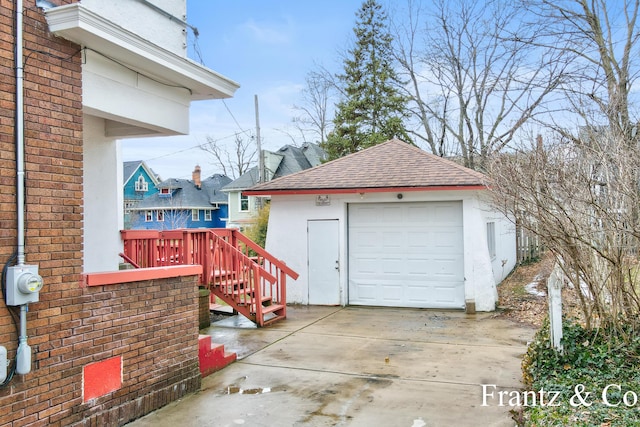 detached garage with concrete driveway