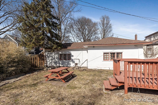 view of yard featuring fence and a wooden deck