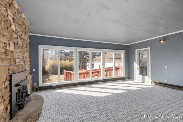 unfurnished living room with crown molding and carpet