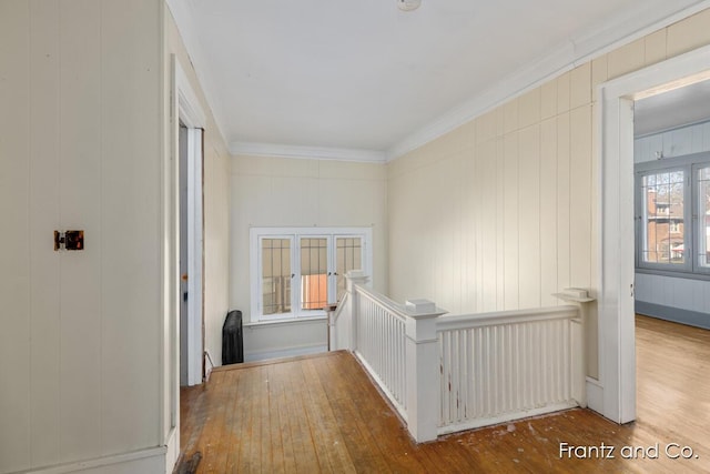 corridor featuring crown molding, an upstairs landing, and wood-type flooring