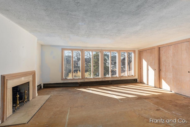 unfurnished living room with a textured ceiling and a tile fireplace