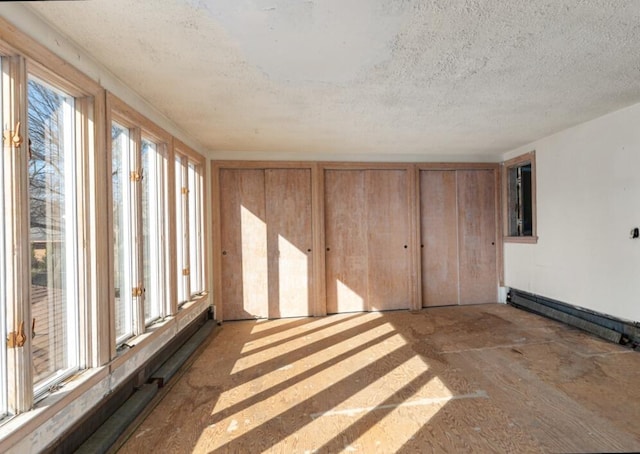 interior space with a wealth of natural light and a baseboard radiator